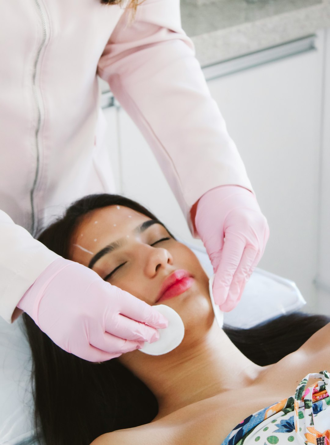 Photo by Studio Michael França A woman getting a facial mask on her face